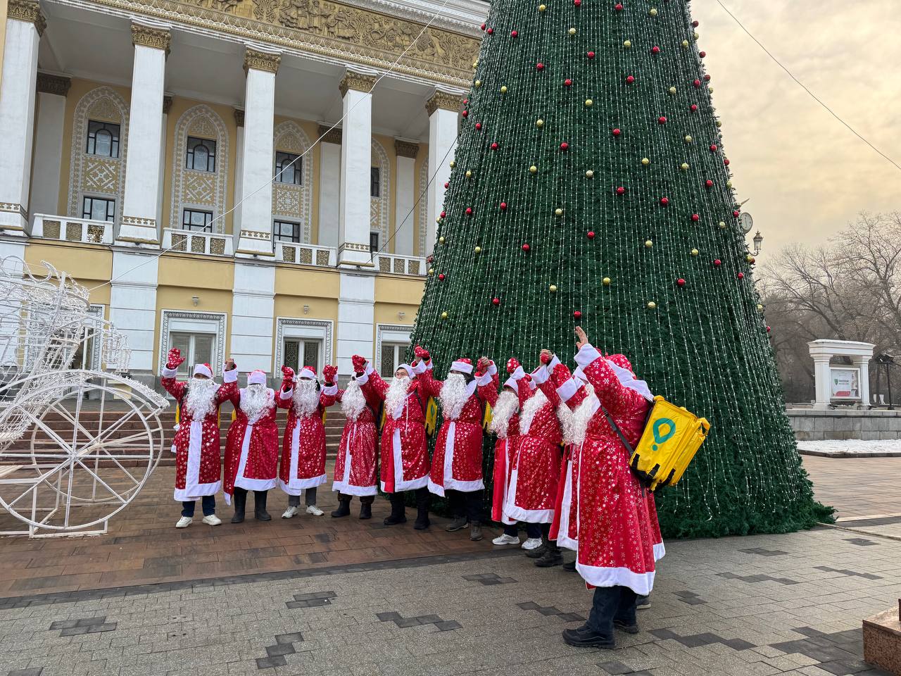 Курьеры Glovo в костюмах Санты подарили новогоднее настроение прохожим на Арбате в Алматы